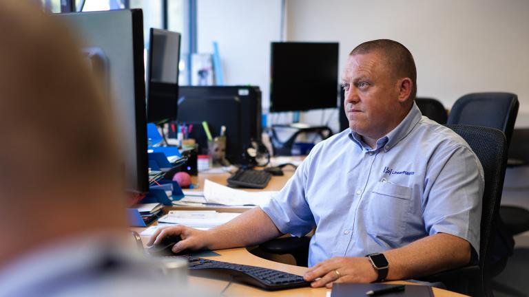 Linear Plastics CAD technician at work in front of his computer